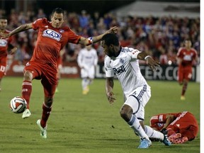 FC Dallas's Blas Perez (left) controls the ball in front of Vancouver Whitecap Kendall Waston during their October 2014 MLS playoff match in Frisco, Texas. Perez, a onetime fierce rival, is now a Whitecap.