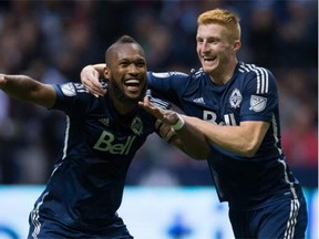 Vancouver Whitecaps' Kendall Waston, left, of Costa Rica, and Tim Parker celebrate Waston's goal against the Houston Dynamo during the second half of an MLS soccer game in Vancouver, B.C., on Sunday October 25, 2015.