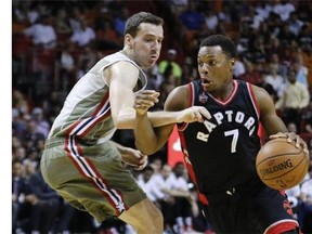 Toronto Raptors guard Kyle Lowry (7) drives past Miami Heat guard Goran Dragic (7) in the first quarter of an NBA basketball game, Sunday, Nov. 8 2015, in Miami. (AP Photo/Joe Skipper)