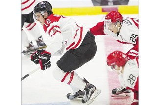 Vancouver Canucks prospect Jake Virtanen of Team Canada skates ahead of Denmark's Niklas Andersen at the world junior hockey tournament Monday in Helsinki, Finland. Canada (1-1), which lost its opener 4-2 to the U.S., outshot the Danes 58-11 and won 6-1. Virtanen is without a point through the two games.