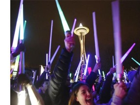 Star Wars fans gather underneath the Space Needle on Saturday, Dec. 19, 2015, to wage a lightsabre battle in Seattle. The battle coincided with the opening weekend of Star Wars: The Force Awakens.