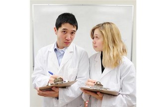 PhD students Benjamin Cheung and Ashley Whillans in action in their lab at UBC in Vancouver, BC., January 14, 2016.
