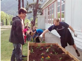 Students at Boston Bar tending garden boxes built to grow vegetables for students and their families.