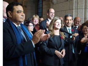 Surrounded by members of caucus Rona Ambrose speaks after being named as the interim-leader of the Conservative party following a caucus meeting Thursday November 5, 2015 in Ottawa.