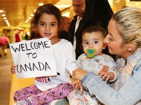 A Syrian family and friends in prepares to welcome relatives sponsored as refugees, at the Calgary Airport this week.