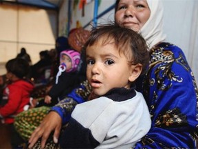 Syrian refugee women and children sit under a tent as they attend a class on family planning organized by Doctors Without Borders at a makeshift camp by Taybeh village, in Lebanon’s eastern Bekaa Valley.