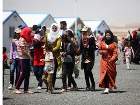 Syrian refugees visit the new market in the Al-Azraq camp for Syrian refugees on April 30, 2015 in Al-Azraq, Jordan. To celebrate the first anniversary of the camp's opening, UNHCR, Care and other partners innaugurated a multi-purpose sports ground, a souk in the market in Village 3, launced the 1st Azraq soccer cup, an open air cinema and other recreational activities for children and adults. The camp is located in the desert 110 km to the east of Amman and not far from the Syrian border