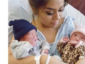 This Jan. 1, 2016 photo provided by Kaiser Permanente San Diego shows Maribel Valencia with her husband Luis and their 3-year-old daughter Isabella, left, holding her newborn twins at the San Diego Kaiser Permanente Zion Medical Center in San Diego. Jaelyn, right, and Luis, who were born just minutes apart but in different years. Jaelyn was born in the last minute of New Year’s Eve 2015 and Luis in the first few minute of New Year’s Day 2016.