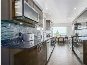 This home at 3315 Westmount Road in West Vancouver has a galley-style kitchen with sleek new cabinets and a glass mosaic tile backsplash.