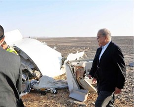 In this image released by the Prime Minister’s office, Sherif Ismail, right, looks at the remains of a crashed passenger jet in Hassana Egypt, Friday, Oct. 31, 2015. A Russian aircraft carrying 224 people, including 17 children, crashed Saturday in a remote mountainous region in the Sinai Peninsula about 20 minutes after taking off from a Red Sea resort popular with Russian tourists, the Egyptian government said. There were no survivors.