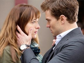 In this image released by Universal Pictures and Focus Features, Dakota Johnson, left, and Jamie Dornan appear in a scene from “Fifty Shades of Grey.”