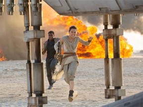This photo provided by Disney/Lucasfilm shows Daisy Ridley, right, as Rey, and John Boyega as Finn, in a scene from the film, Star Wars: The Force Awakens, directed by J.J. Abrams.