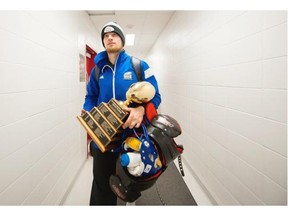 UBC Thunderbirds quarterback Michael O’Connor walks to the bus with his MVP trophy after defeating the University of Montreal Carabins in the 51st Vanier Cup final at Laval University in Quebec,