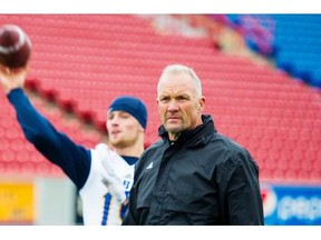 UBC Thunderbirds quarterback Michael O’Connor warms up under the watchful eye of head coach Blake Nill.