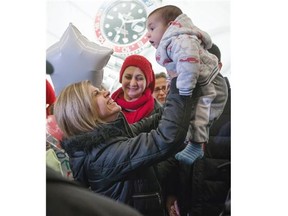 Tima Kurdi, left, who lives in the Vancouver area, lifts up her 5-month-old nephew Sherwan Kurdi after her brother Mohammad Kurdi and his family, who escaped the war in Syria, arrived at Vancouver International Airport, in Richmond, B.C., on Monday, Dec. 28, 2015. Tima Kurdi’s other brother Abdullah, whose young sons and wife died when their boat capsized during a desperate voyage from Turkey to Greece, abandoned his attempt to emigrate. Looking on at centre is Haveen Kurdi, 16, Mohammad’s eldest daughter.