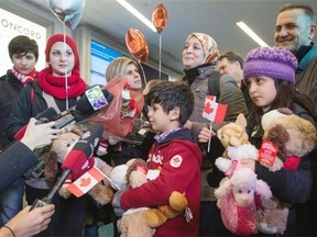 Tima Kurdi, third from left, who lives in the Vancouver area, stands with her brother Mohammad Kurdi, top right, and his family, who escaped the war in Syria, upon arrival at Vancouver International Airport in Richmond, B.C., on Monday December 28, 2015. Pictured, from left to right, are Shergo Kurdi, 15, Haveen Kurdi, 16, Sherwan Kurdi, 5-months, being held by Tima, Rezan Kurdi, 8, their mom Ghousun Kurdi and Ranim Kurdi, front right, 10. Tima Kurdi’s other brother Abdullah, whose young sons and wife died when their boat capsized during a desperate voyage from Turkey to Greece, abandoned his attempt to emigrate.