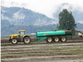 A tractor spreading manure on a farm. Water warnings have been issued for the Hulcar aquifer in Spallumcheen, where the province allows manure spraying on fields.
