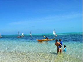 Island Expeditions guests sail kayaks from Half Moon Caye to Long Caye.