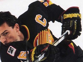 Trevor Linden rocks the black jersey of the Vancouver Canucks in the 1990s, for a hockey card of that era.