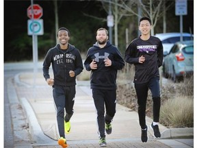 University Hill’s athletic director Jeff Hodgson (centre) with students Kingsley Okorji (left) and Joseph Park as they all prepare for the upcoming Vancouver Sun Run.