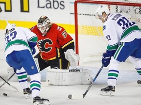 Vancouver Canucks Daniel (left) and Henrik Sedin challenge Calgary Flames goalie Karri Ramo during the 2015-16 season opener for both teams, the last time they faced each other in Calgary. The Canucks won that game 5-1, and hope history repeats itself as the club tries to snap a three-game losing streak.