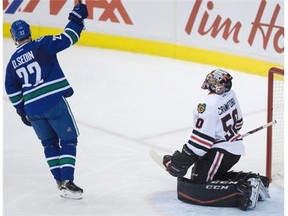 Vancouver Canucks’ Daniel Sedin, of Sweden, celebrates his goal against Chicago Blackhawks’ goalie Corey Crawford during second period NHL hockey action, in Vancouver, B.C., on Saturday, Nov. 21, 2015.