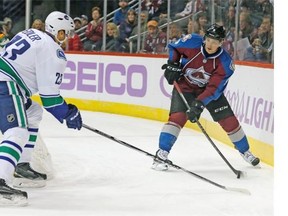 Vancouver Canucks defenceman Alexander Edler, left, of Sweden, pursues Colorado Avalanche centre Matt Duchene as he tries to pass the puck.