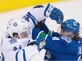 Vancouver Canucks defenseman Chris Tanev (8) pushes Toronto Maple Leafs center Nazem Kadri (43) during the first period of NHL action in Vancouver, B.C. Saturday, March. 14, 2015.