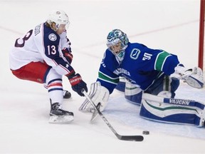 Vancouver Canucks goalie Ryan Miller stops a shot by Columbus Blue Jackets #13 Cam Atkinson in the shoot out of a regular season NHL hockey game at Rogers Arena, Vancouver, February 04 2016.