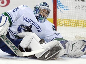 Vancouver Canucks goaltender Ryan Miller makes a save during the first period of an NHL hockey game against the Buffalo Sabres, Saturday Nov. 7, 2015 in Buffalo, N.Y.