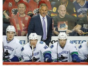 Vancouver Canucks head coach Willie Desjardins has some words for the officials, not necessarily his team, during an NHL game last season.