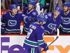 Vancouver Canucks’ Jake Virtanen (18) celebrates his goal against the Philadelphia Flyers with teammates Derek Dorsett (15), Jared McCann (91), Adam Cracknell (24) and Yannick Weber during third period NHL hockey action in Vancouver, B.C., on Monday, November 2, 2015.