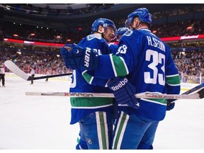 Vancouver Canucks #36 Jannik Hansen ( L ) celebrates his goal on the Edmonton Oilers goalie Cam Talbot with teammates #23 Alexander Edler ( C ) and #33 Henrik Sedin ( R ) in the first period of a regular season NHL hockey game at Rogers arena, Vancouver December 26 2015.