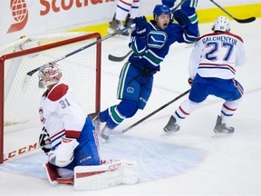 Vancouver Canucks’ Jared McCann, centre, celebrates his goal against Montreal Canadiens’ goalie Carey Price, left, in front of Alex Galchenyuk during the first period of an NHL hockey game in Vancouver, B.C., on Tuesday, Oct. 27, 2015.