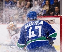 Vancouver Canucks #47 Sven Baertschi is showered in ice chips in front of  Anaheim Ducks goalie John Gibson in the first period of a regular season NHL hockey game at Rogers Arena, Vancouver, February 18 2016.