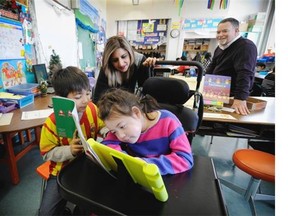 Karl Graham, principal at Moberly elementary school where they are working to get more iPads which help many of their special needs students. Deion Kahlon, 8, reads with Melissa Blue, 8,  (in wheelchair).  Teacher aid Sharon Sidhu (rear left) encourages the students.