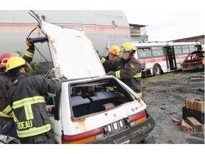 Vancouver firefighters remove the roof during a car rescue exercise at the training facility, Nov. 18, 2015.