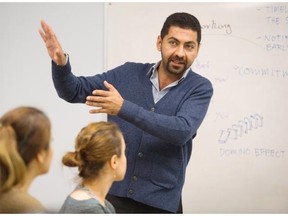 Masud Azar, a family and youth outreach worker, teaches a class to refugees at SUCCESS,  Vancouver November 27 2015.