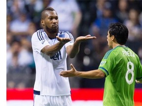 Vancouver Whitecaps centre back Kendall Waston (left) and the Seattle Sounders’ Gonzalo Pineda exchange points of view during the second half of their Major League Soccer game at BC Place Stadium on Sept. 19, 2015.