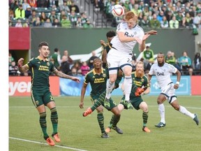 Vancouver Whitecaps defender Tim Parker (26) goes up for a corner kick during the first half of an MLS western conference semifinal soccer match against the Portland Timbers in Portland, Ore., Sunday, Nov. 1, 2015.