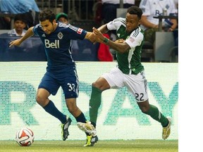 Vancouver Whitecaps fullback Steven Beitashour (left), seen battling with Portland Timbers midfielder Rodney Wallace, says keeping Portland off the scoresheet on Sunday ‘might be bigger’ than scoring the first goal.