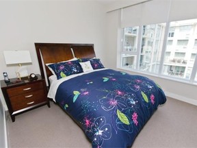 VICTORIA, B.C.: AUGUST 25, 2015-Master bedroom in Seaport Place  in    Victoria, B.C. August  25, 2015. (DARREN STONE, TIMES COLONIST). For Life story by Grania Litwin. *** Local Caption *** Sandy and Bill Haun -  The master bedroom is simply furnished in dark oak. Sat Sep 26 2015  Page: E1 / Front  Section: Homes  Byline: Grania Litwin  Column: House Beautiful