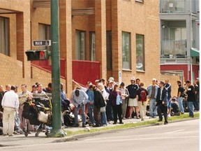 Welfare recipients line up for their cheques near the office at Powell and Main in Vancouver.