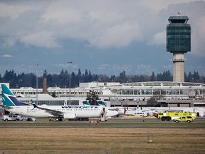A Westjet Boeing 737-800 aircraft sits parked on the south runway after aborting a takeoff due to a blown tire at Vancouver International Airport in Richmond, B.C., on Monday February 1, 2016. The incident forced the closure of the runway and all arrivals and departures were moved to the north runway. THE CANADIAN PRESS/Darryl Dyck