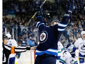 Winnipeg Jets’ Drew Stafford (12) celebrates his goal against the Vancouver Canucks during second period NHL action in Winnipeg on Wednesday, November 18, 2015.