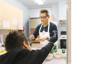 Old Yale Elementary in Surrey provides a breakfast, snack and lunch program for between 40 and 50 children daily. Doy Valenciano is the breakfast co-ordinator behind the counter serving the children.