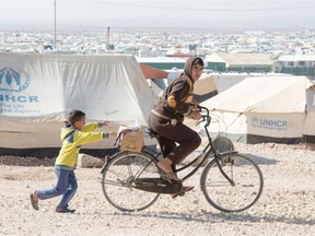 Young Syrian refugees play in the Zaatari refugee camp, near the city of Mafraq, Jordan.