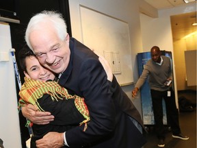 Immigration Minister John McCallum hugs a Syrian refugee boy at a photo opportunity in March with the Vancouver Canucks.