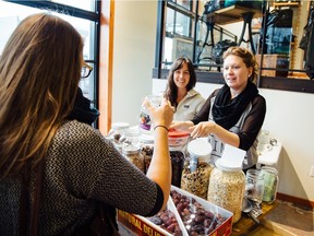 Brianne Miller (left), founder of Zero Waste Market, with volunteer Heather McIntosh (right), and shopper Frances Robertson (foreground).