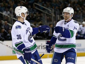 Daniel Sedin #22 of the Vancouver Canucks is congratulated by Jannik Hansen #36 after he scored a goal against the San Jose Sharks at SAP Center on March 31, 2016 in San Jose, California.  (Photo by Ezra Shaw/Getty Images)